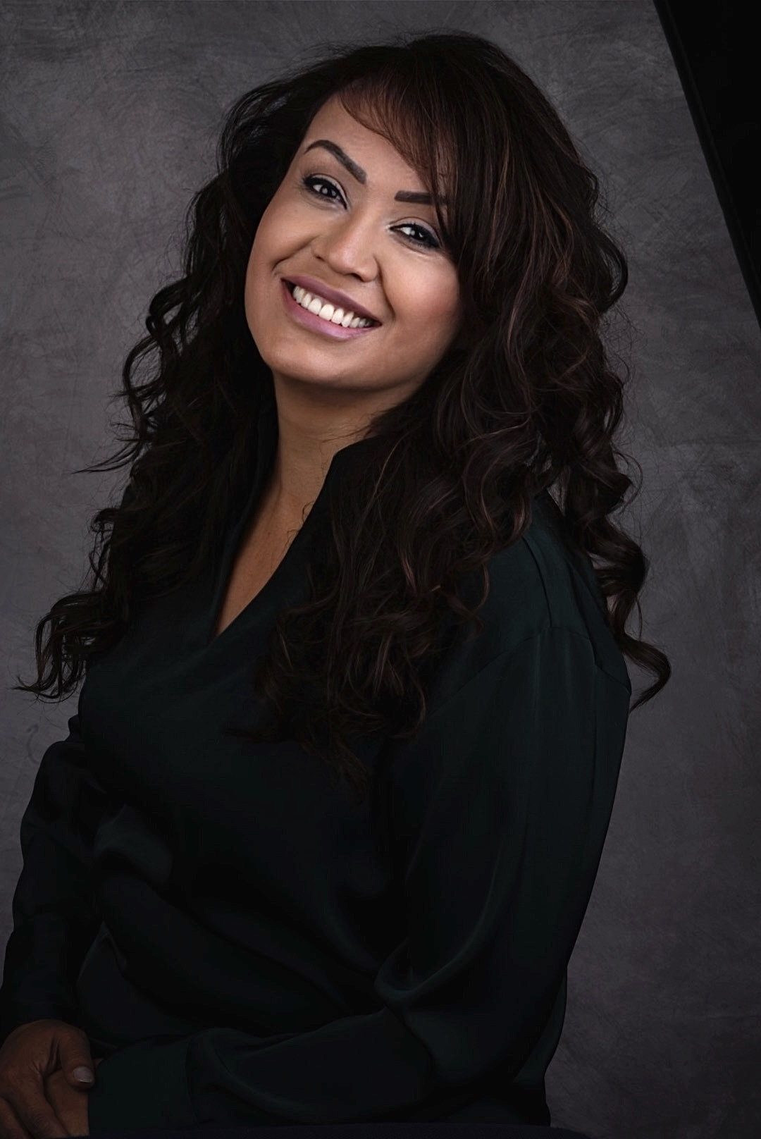 Patient smiling with confidence after treatment with Dr. Marta