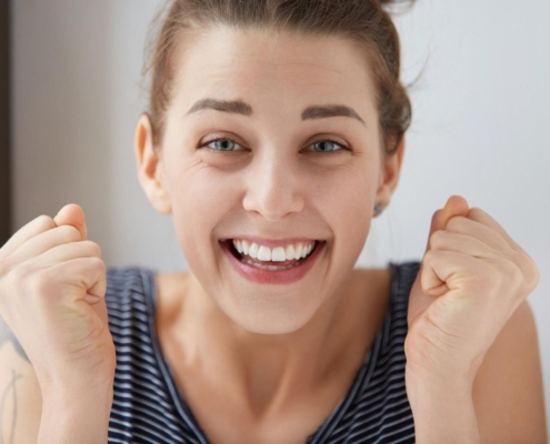 Smiling girl with straight aligned teeth