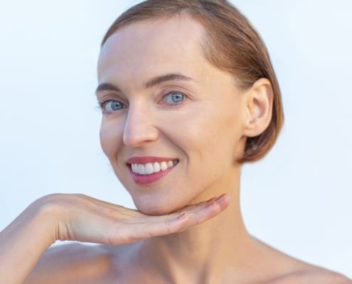 Woman smiling after professional teeth whitening treatment