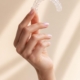 Clear Invisalign aligner held in a woman's hand